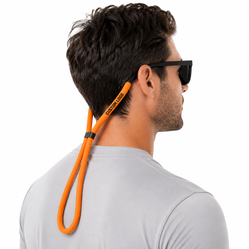 Person wearing a floating sunglasses strap during outdoor activities