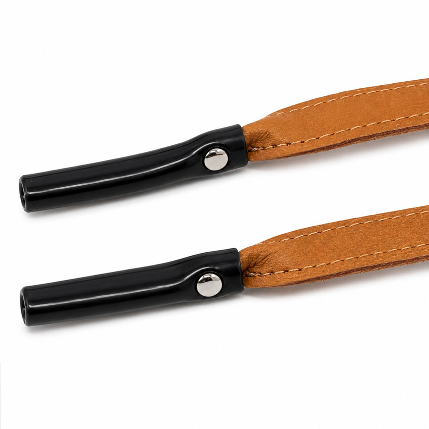 Close-up view of riveted rubber temple ends on a custom leather sunglasses strap