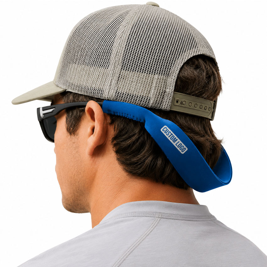 Man wearing a blue neoprene sunglasses strap during outdoor activities