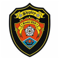 Professional shield-shaped woven patch for Shipley Scooter Club featuring a white rose and sailboat emblem, vintage-style biker club clothing accessory.