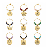 Custom wine glass charms featuring gold-tone rings, colorful beads, and personalized logo charms in various shapes for wineries, events, weddings, and promotional gifts.
