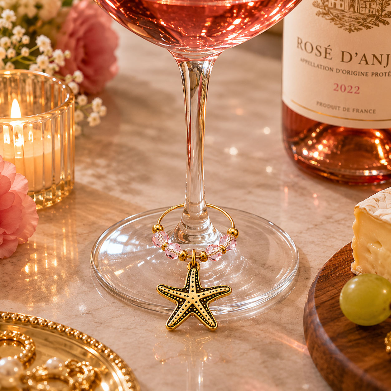 Personalized starfish wine glass charm with decorative crystal beads and gold-tone ring, displayed on a rosé wine glass for coastal weddings, beach events, wineries, and branded gifts.