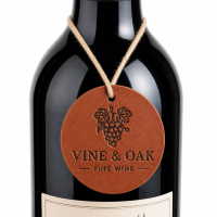 Round leather wine bottle neck tag featuring a custom debossed logo