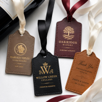 Personalized leather gift tags with foil stamped logos and satin ribbon attachments