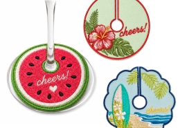 Custom embroidered wine stem tags in different designs fitted around wine glass stems