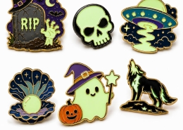 Collection of six luminous enamel pins featuring Halloween, UFO, pearl, ghost, and wolf designs.