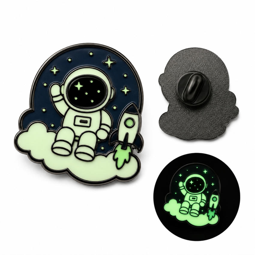 Custom Astronaut Glow-in-the-Dark Enamel Pin Astronaut enamel pin with rocket and clouds, shown with black pin back and glowing dark-view sample.