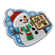 Custom Snowman Embroidered Fridge Magnet with 100% Full Embroidery and Clean-Cut Edge Angled close-up of a snowman embroidered fridge magnet with raised thread texture, blue stitched border and Christmas design